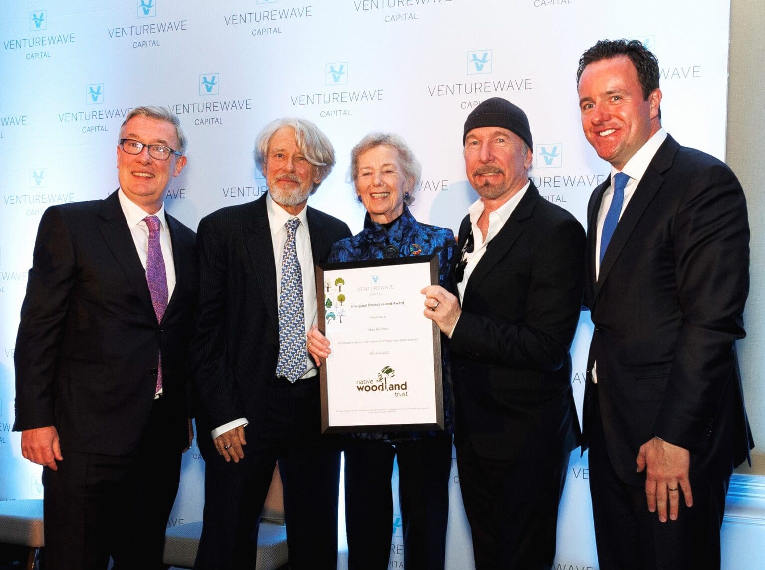 Mary Robinson receives the inaugural Impact Ireland Award for sustainability from The Edge and Adam Clayton, alongside Venturewave Capital leadership.