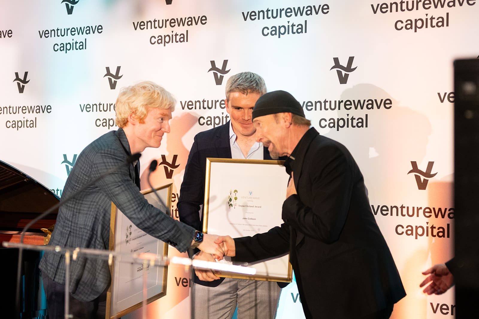 Patrick and John Collison receiving the Impact Ireland Award from The Edge at the Impact Ireland 2025 Gala Dinner in Dublin